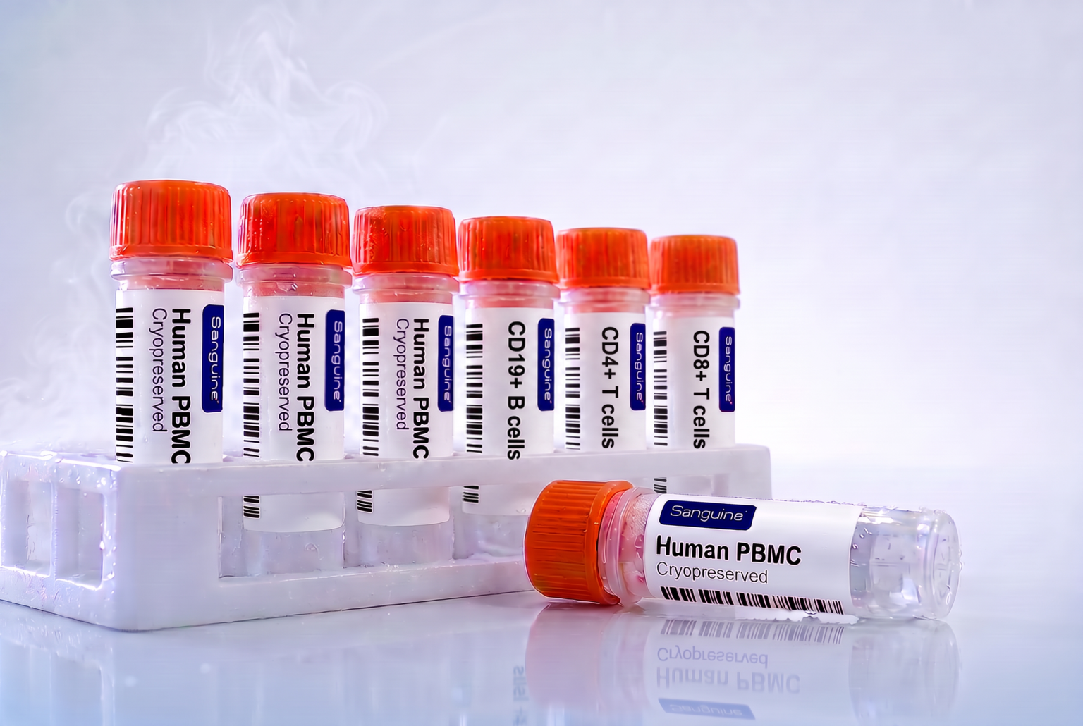 Orange-cap cryovials with fine condensation and vapor rising, as if just removed from a liquid nitrogen dewar